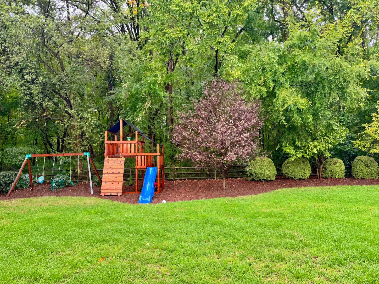 A resident’s backyard and children’s playset directly adjoining the proposed development site.